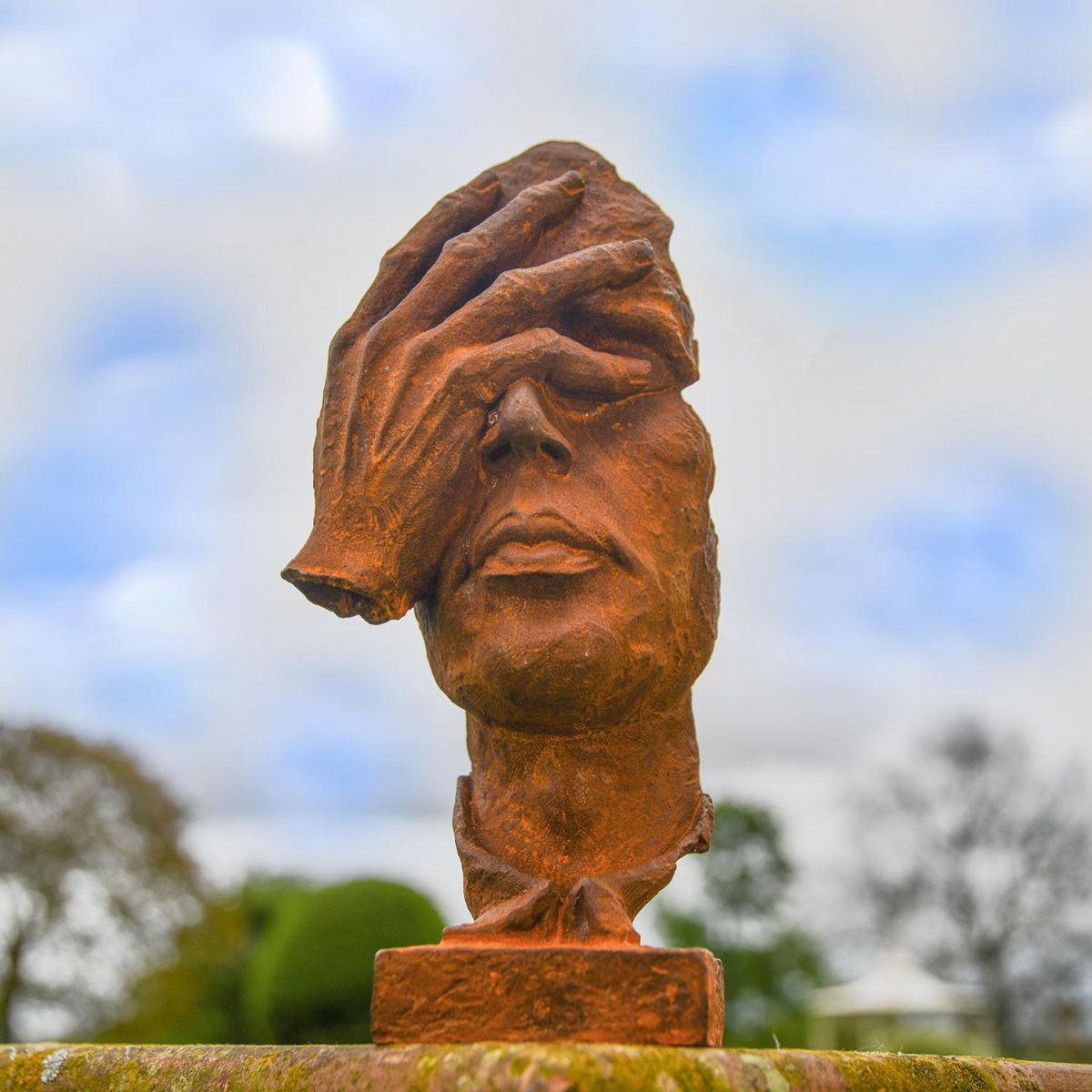 Rustic Cast Iron Abstract Face Sculpture in situ