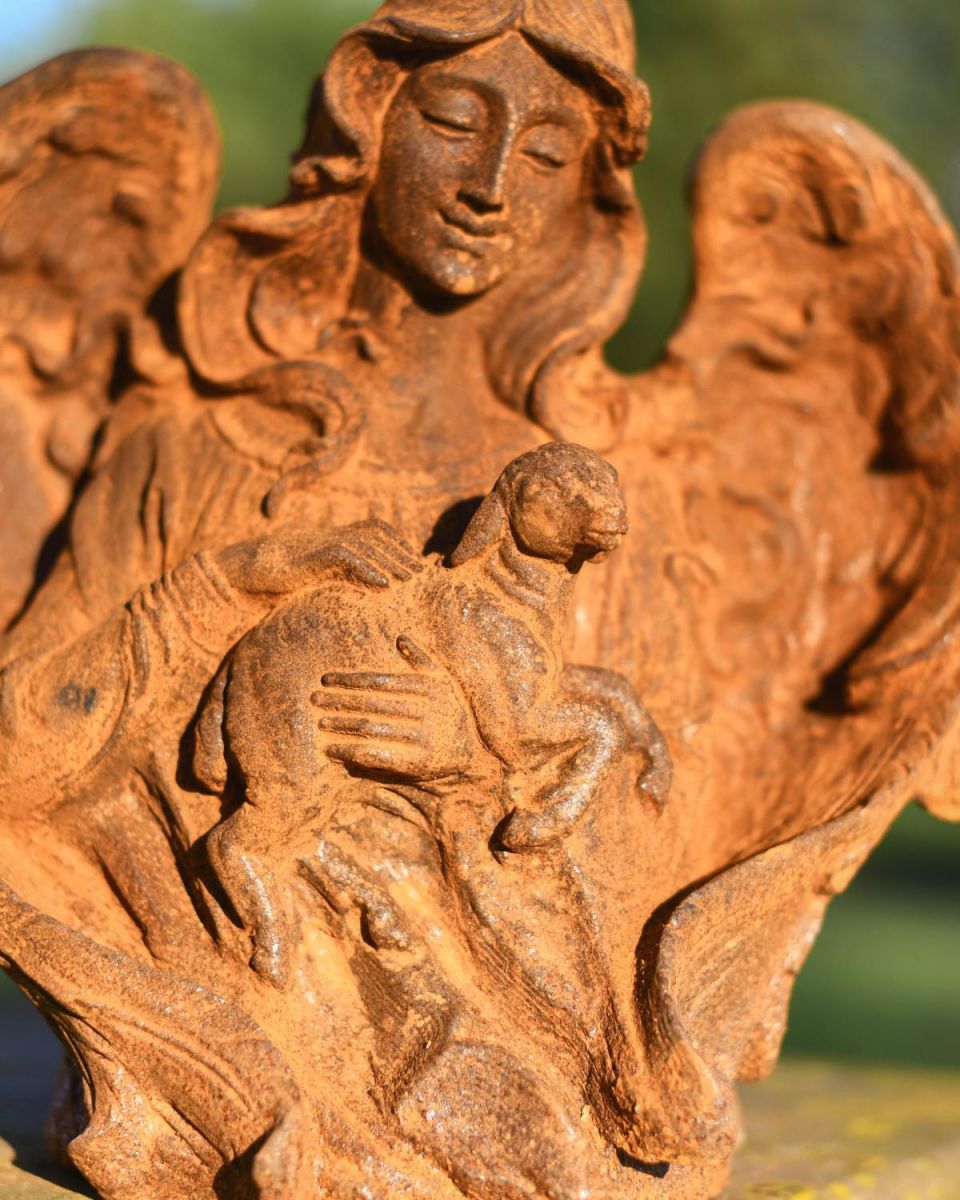 Close-Up of Rustic Cast Iron "Arched Angel" with Lamb Garden Sculpture