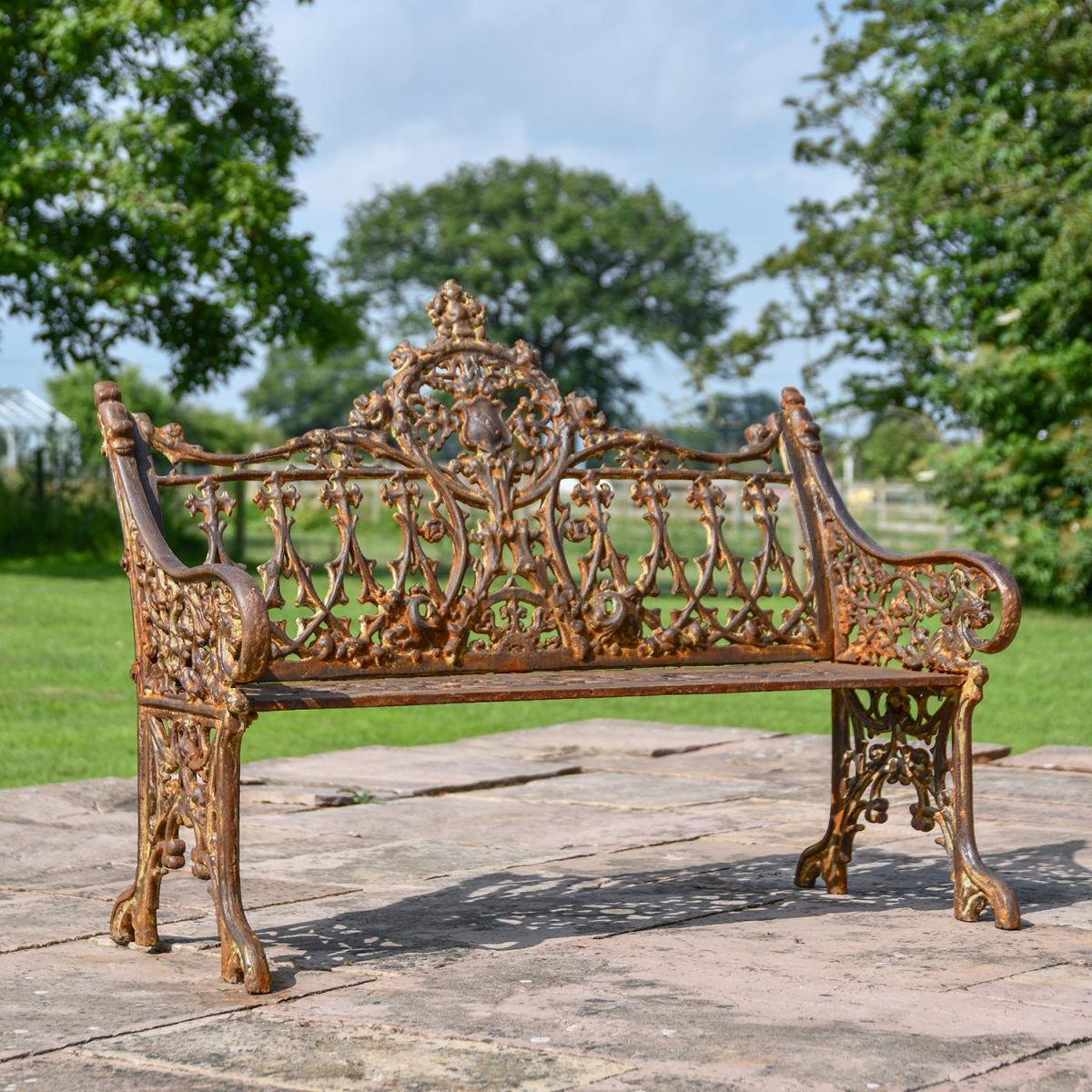 Rustic Cast Iron Gothic Two Seat Bench in Use in the Garden