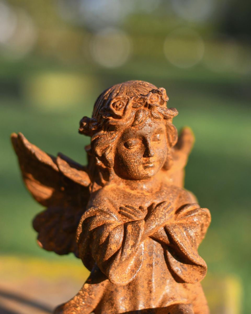 Close-Up of Rustic Cast Iron "Kneeling Angel" Garden Sculpture