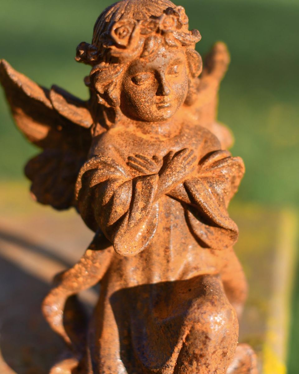 Close-Up of Rustic Cast Iron "Kneeling Angel" Garden Sculpture