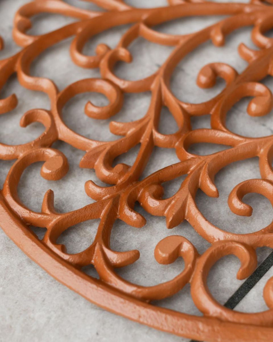 Close-Up of Ornate Pattern on Rustic Cast Iron Door Mat