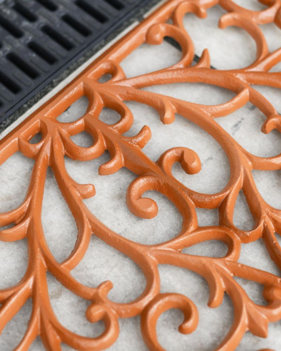 Close-Up of Rustic Cast Iron Ornate "Sunrise" Semi Circle Door Mat