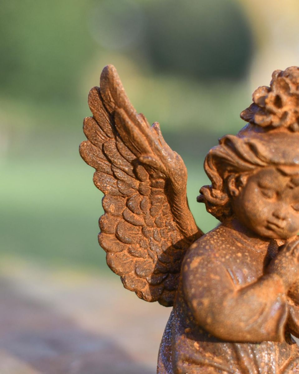 Close-Up of Rustic Cast Iron "Petitioning" Angel Garden Sculpture