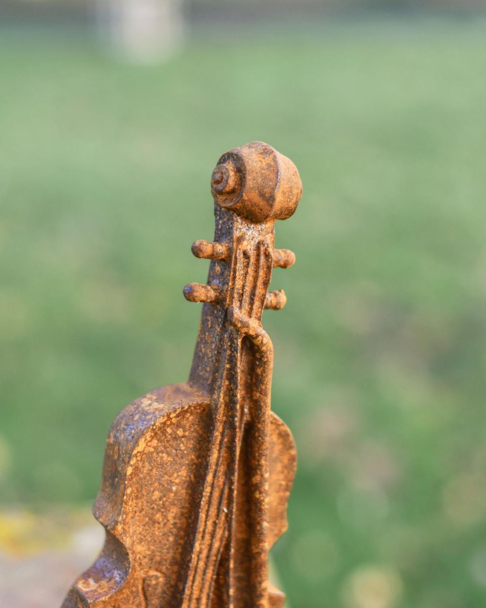 Close-Up of Violin on Freestanding Garden Sculpture Close-Up of Violin on Freestanding Garden Sculpture