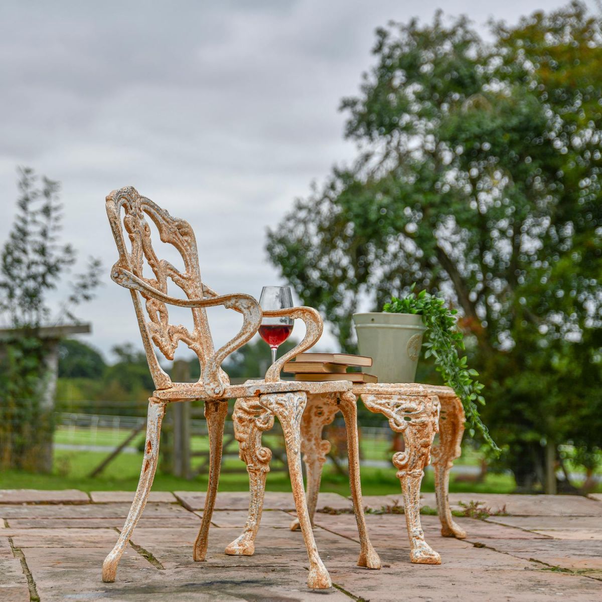 Rustic Cream Cast Iron Victorian Chair in Use Outside