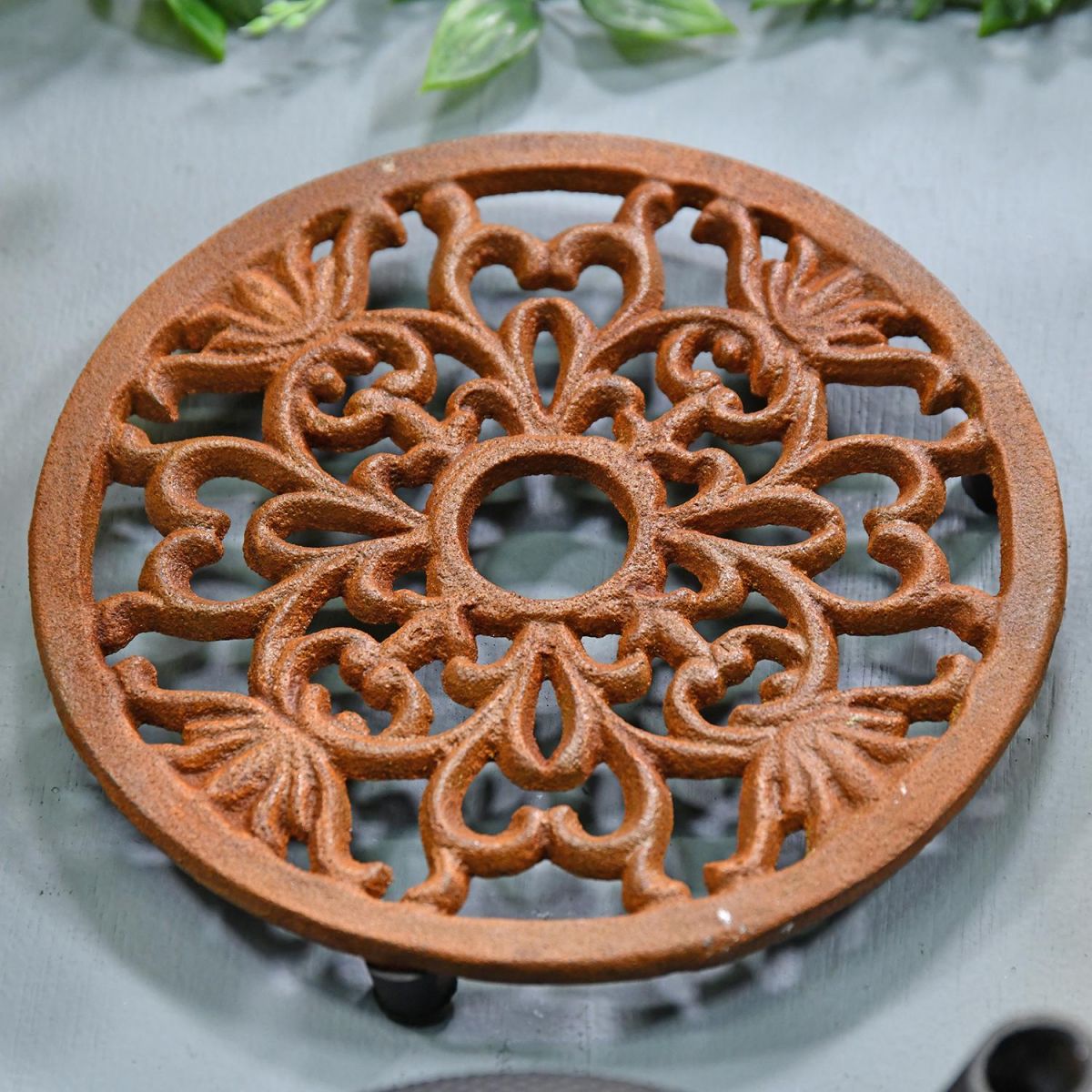 Heavy Duty Cast Iron Round Trivet Being Used on a Dining Room Table
