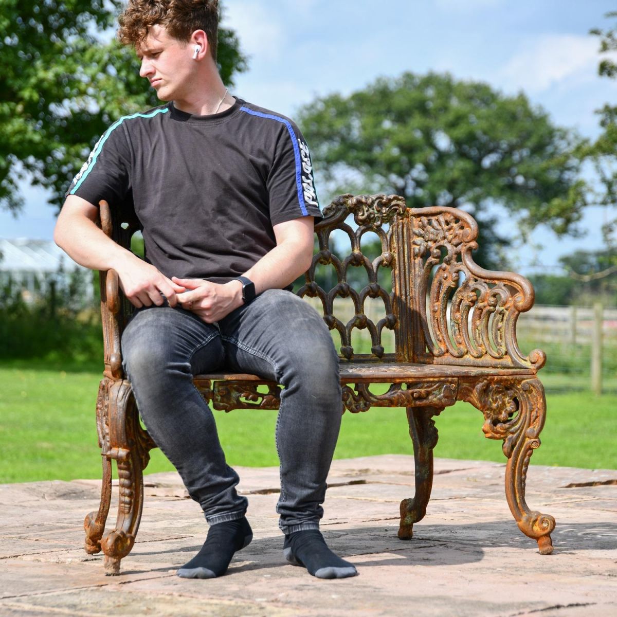 Rustic Ornate Garden Bench with Male for scale 