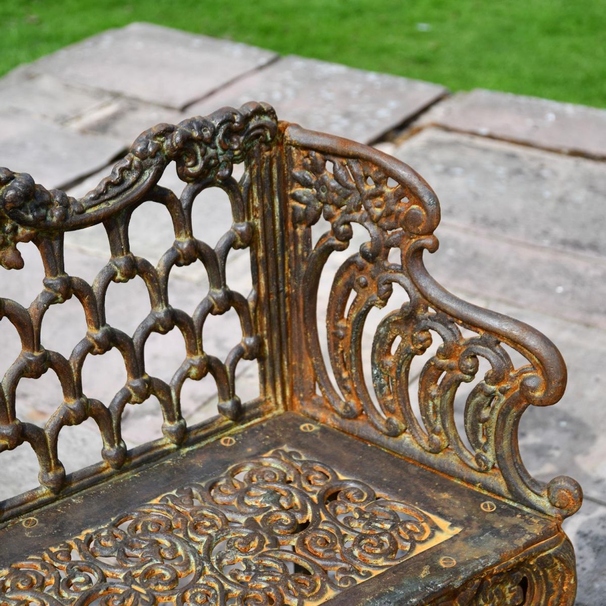 Close up of rustic cast iron garden bench 