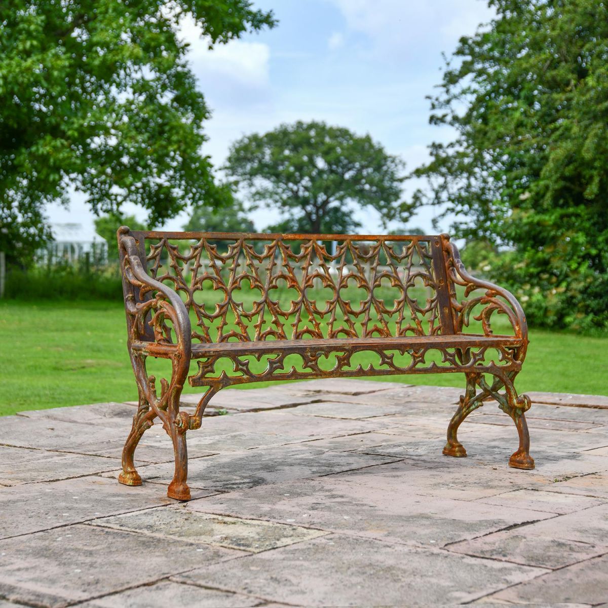 Rustic "Quatrefoil" Victorian Cast Iron Two Seat Bench in Use on the Garden Patio