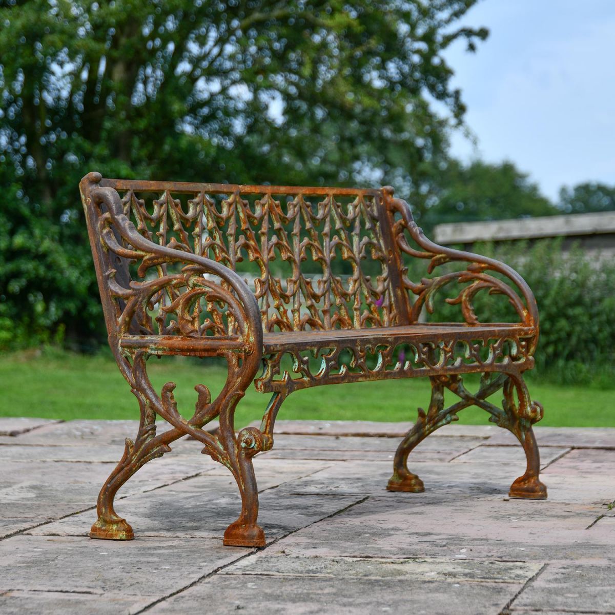 Rustic "Quatrefoil" Victorian Cast Iron Two Seat Bench in Use in the Garden