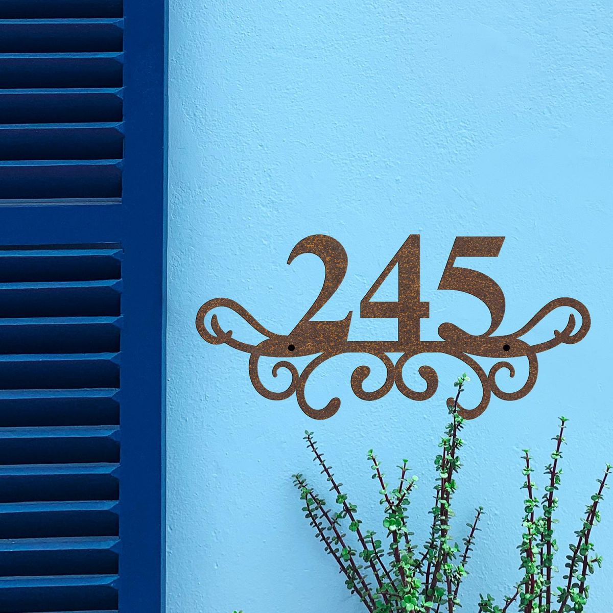 Traditional Iron Ornate Number Sign on a Blue Wall