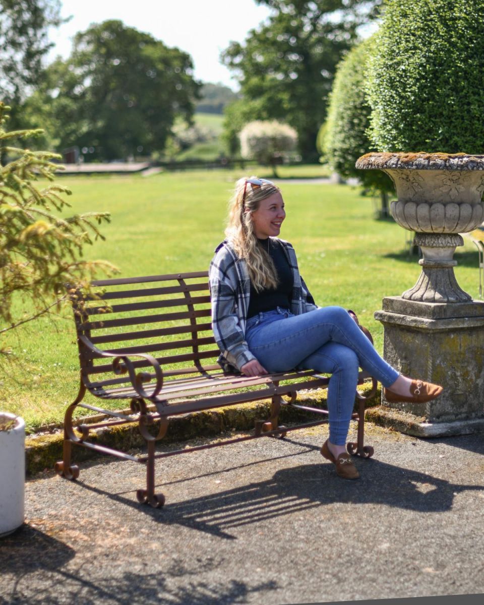 Scale Shot of Rustic Wrought Iron “Chatham" Two Seater Garden Bench