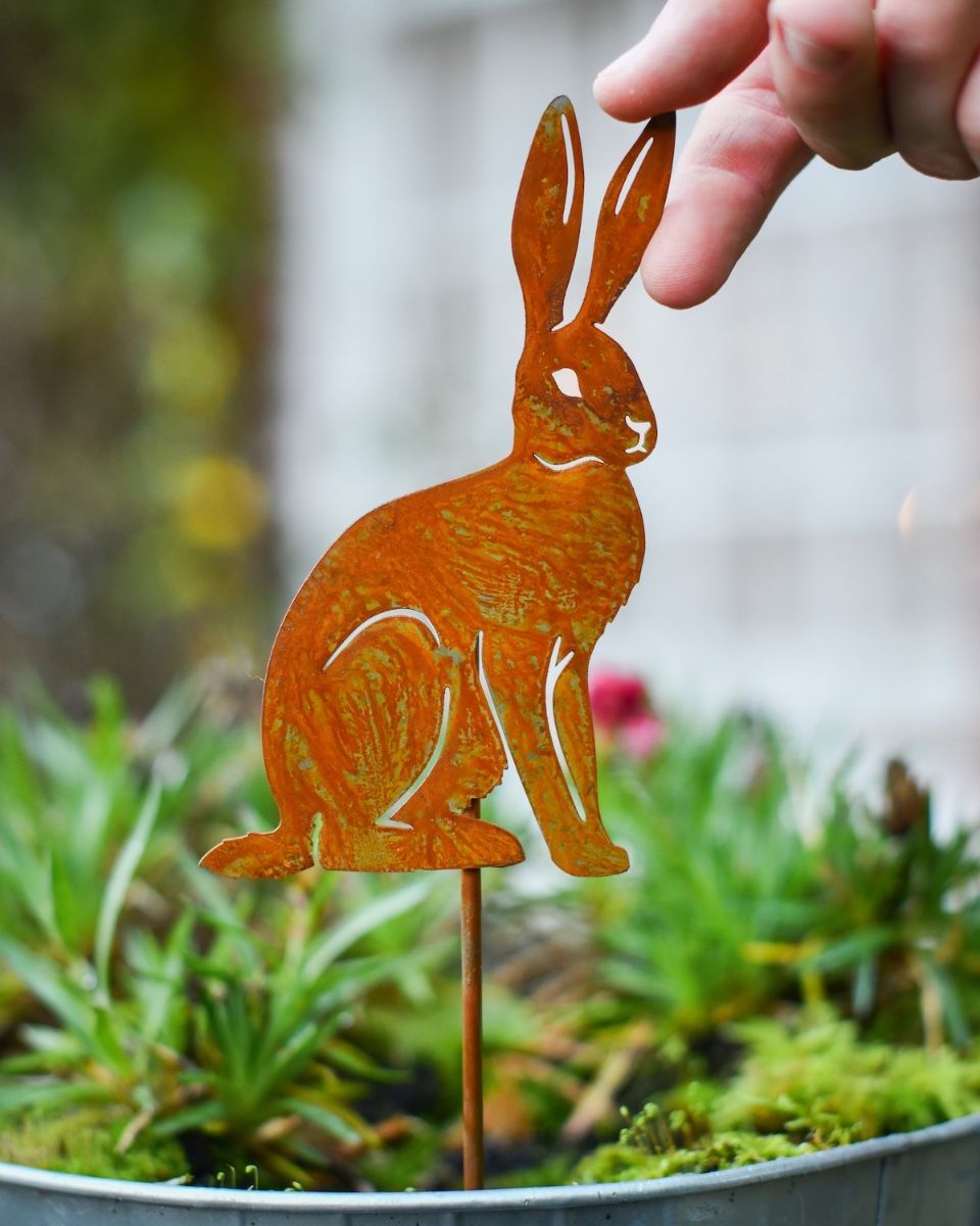 Rusting Sitting Hare Artistic Plant Pot Spike - Set of Two with hand in shot for scale