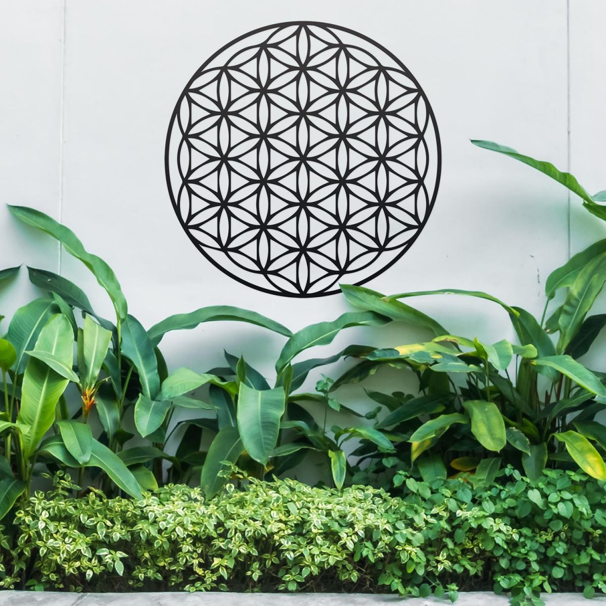 Geometry "Flower of Life" Steel Wall Art Above Bushes in the Garden