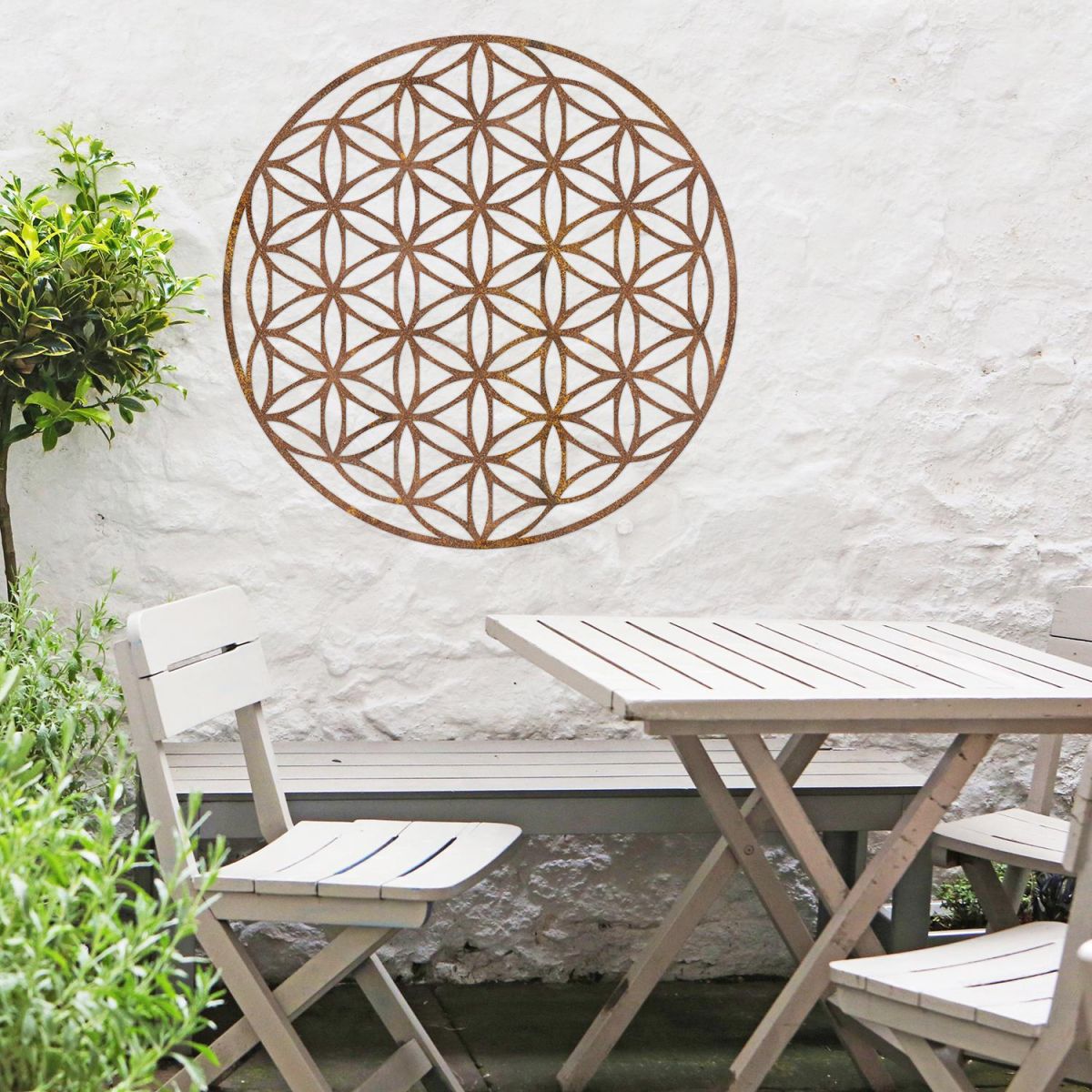 Geometry "Flower of Life" Steel Wall Art in Situ Outside Above a Wooden Table Set