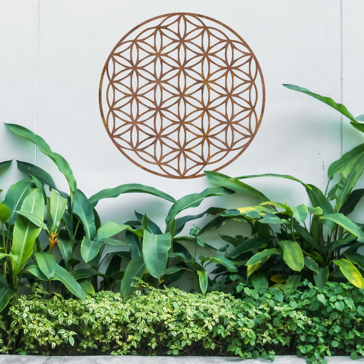 Geometry "Flower of Life" Steel Wall Art Above Bushes in the Garden