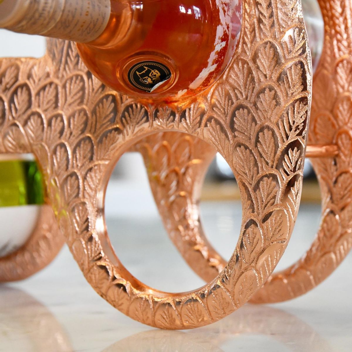 Close up of circular bottle holder within Copper "Angel Wings" Wine Rack 