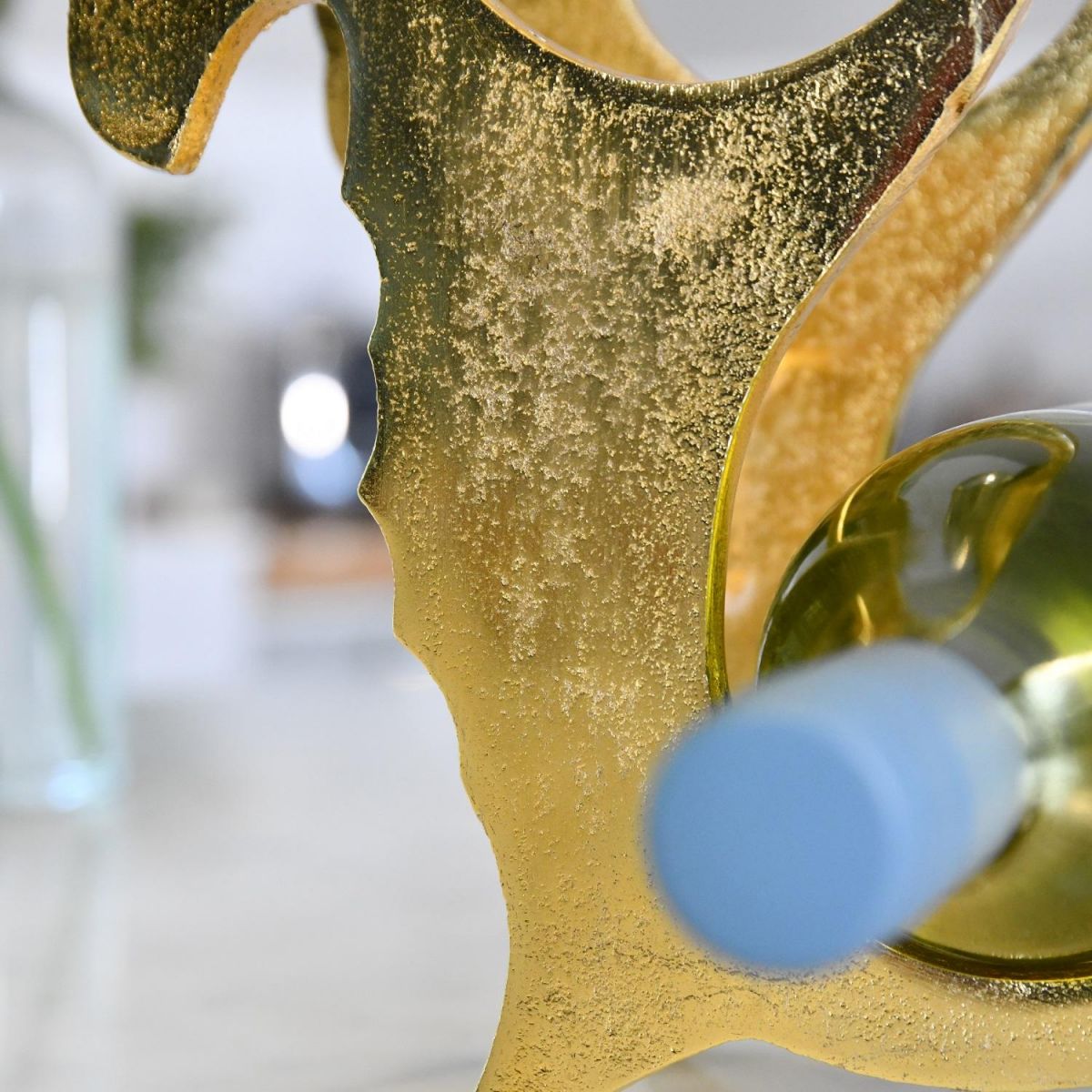 Close up of Gold "Seahorse" with wine bottle 