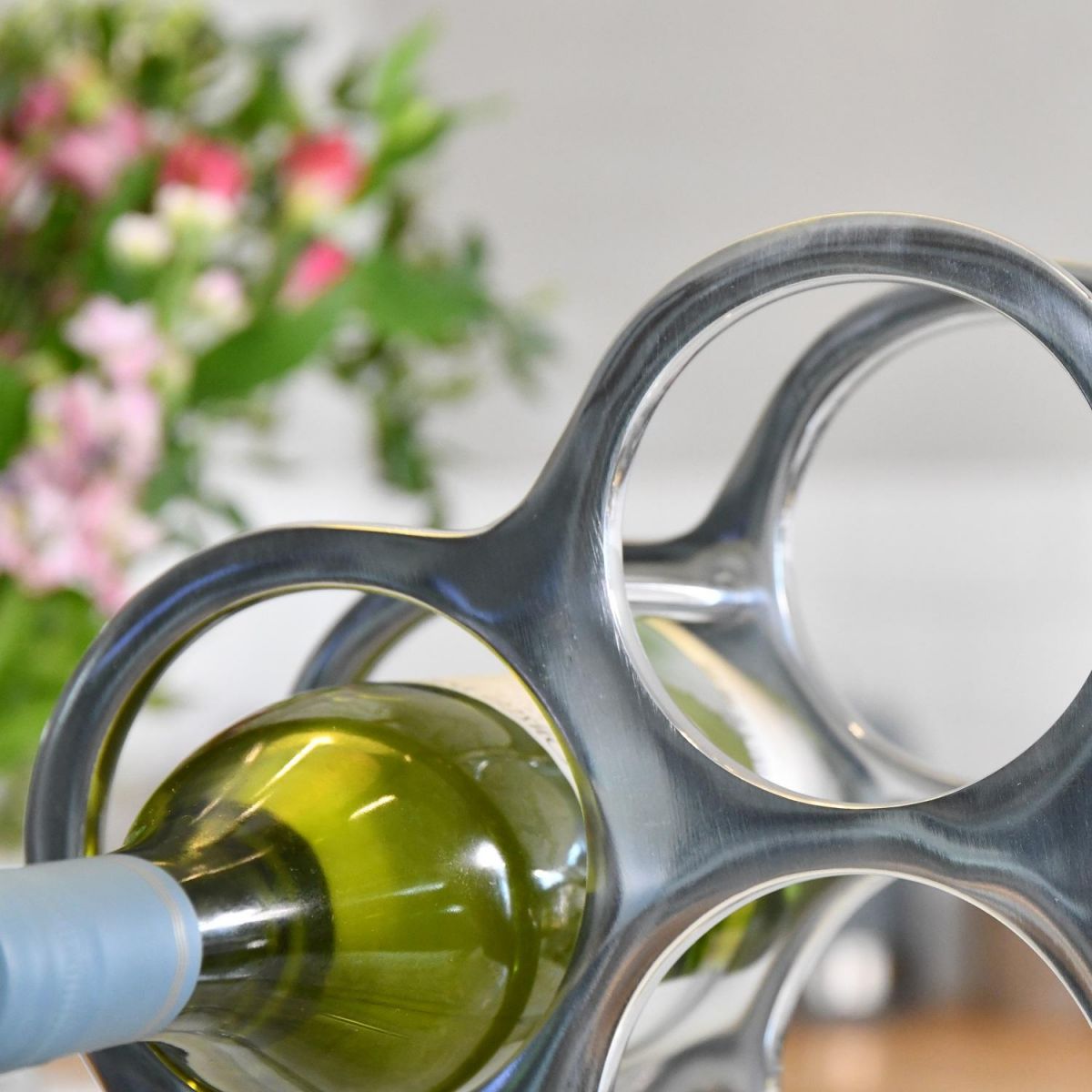 Close up of circular holder with wine bottle  Close up of circular holder with wine bottle