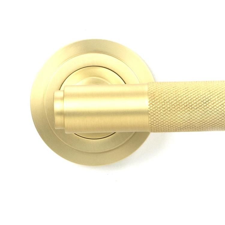 Close-Up of Satin Brass "Royale" Art-Deco Concealed Door Handle on Rose Set