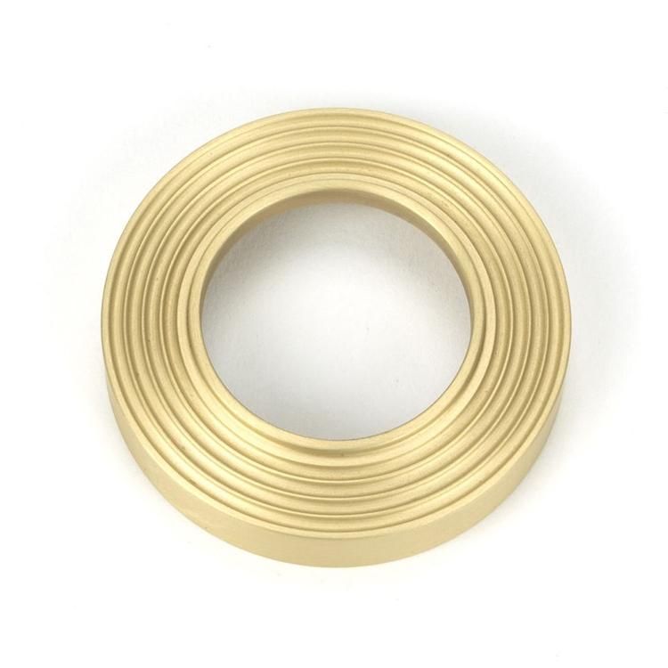 Close-Up of Backplate for Satin Brass "Royale" Beehive Concealed Door Handle on Rose Set Close-Up of Backplate for Satin Brass "Royale" Beehive Concealed Door Handle on Rose Set