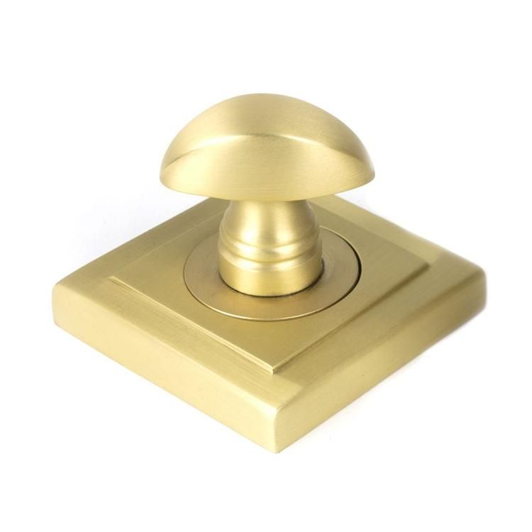 Close-Up of Single Satin Brass Square "Vienna" Round Bathroom Thumb Lock
