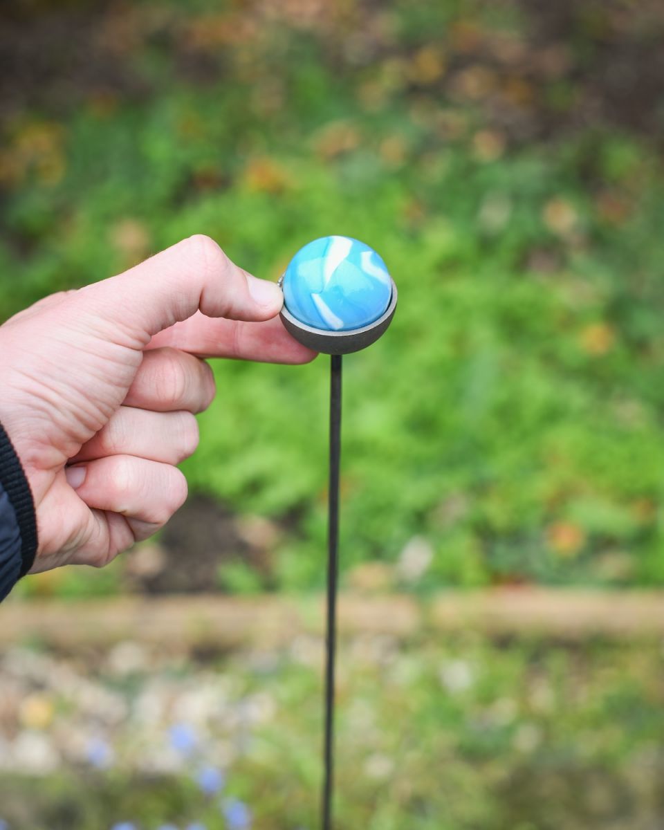 Close up of blue suncatcher plant pot stake