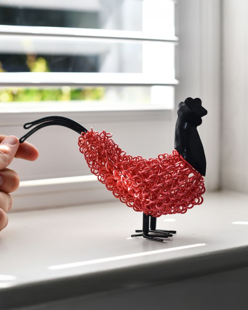 Scale image of colourful recycled cockerel sculpture