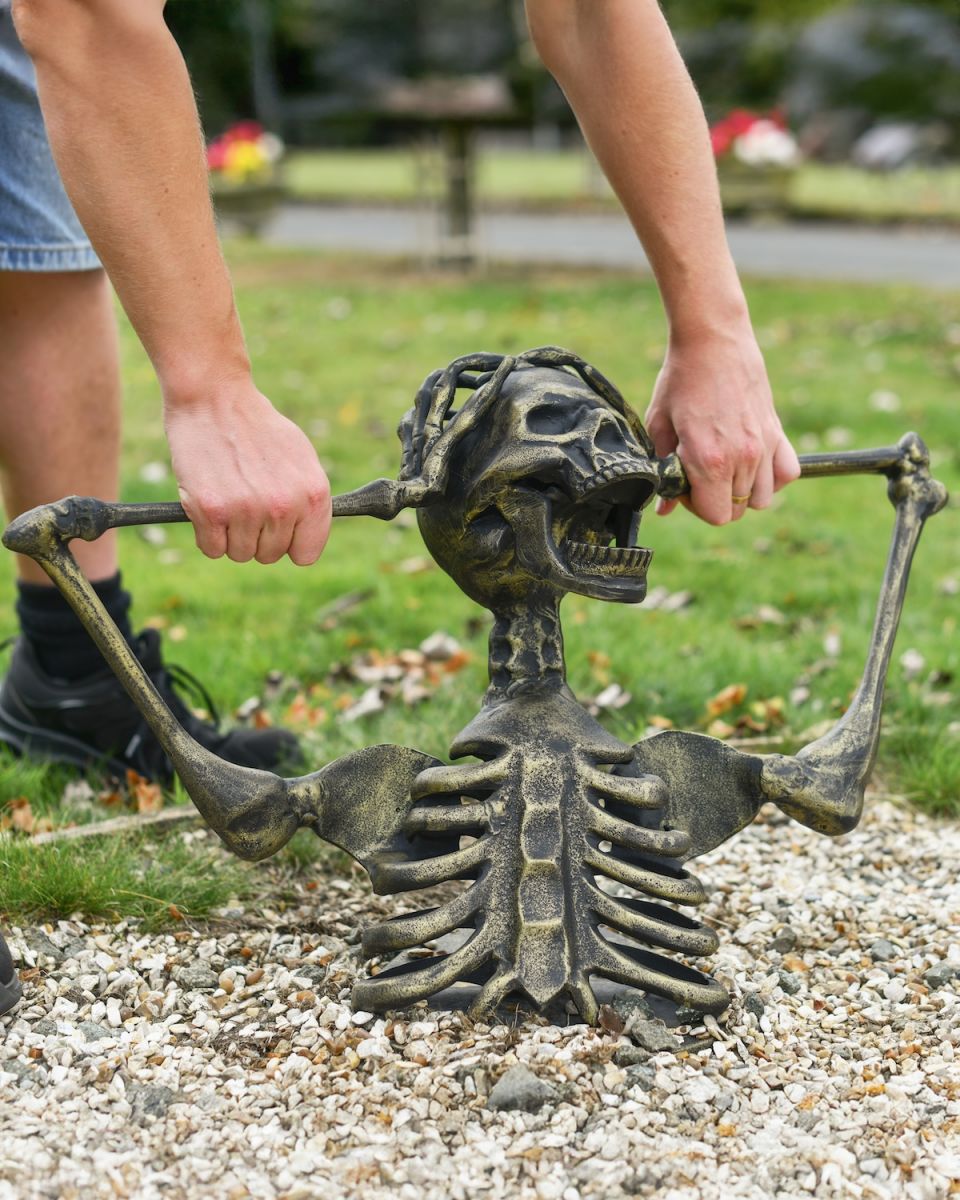 Scale image of screaming half skeleton garden statue