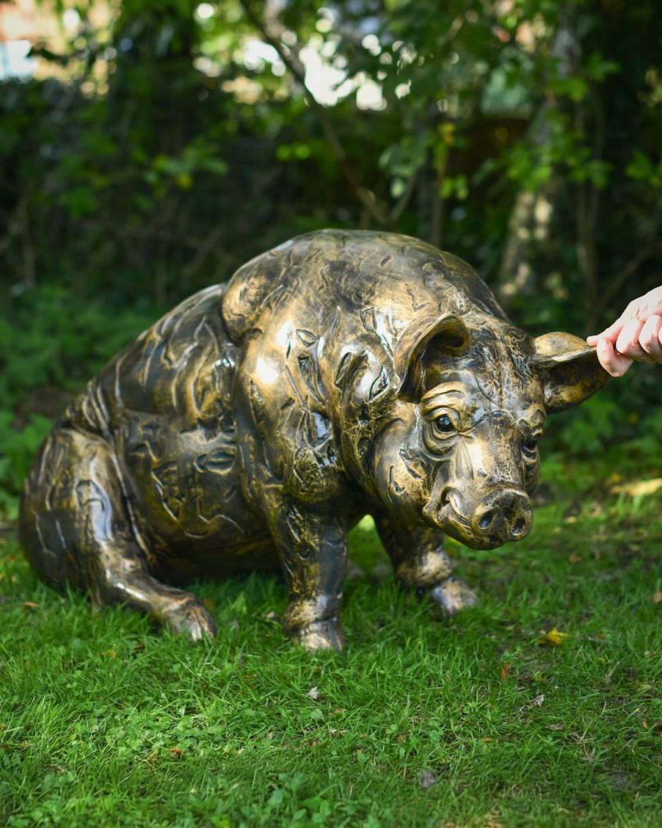 Scale image of brushed gold sitting pig outdoor statue