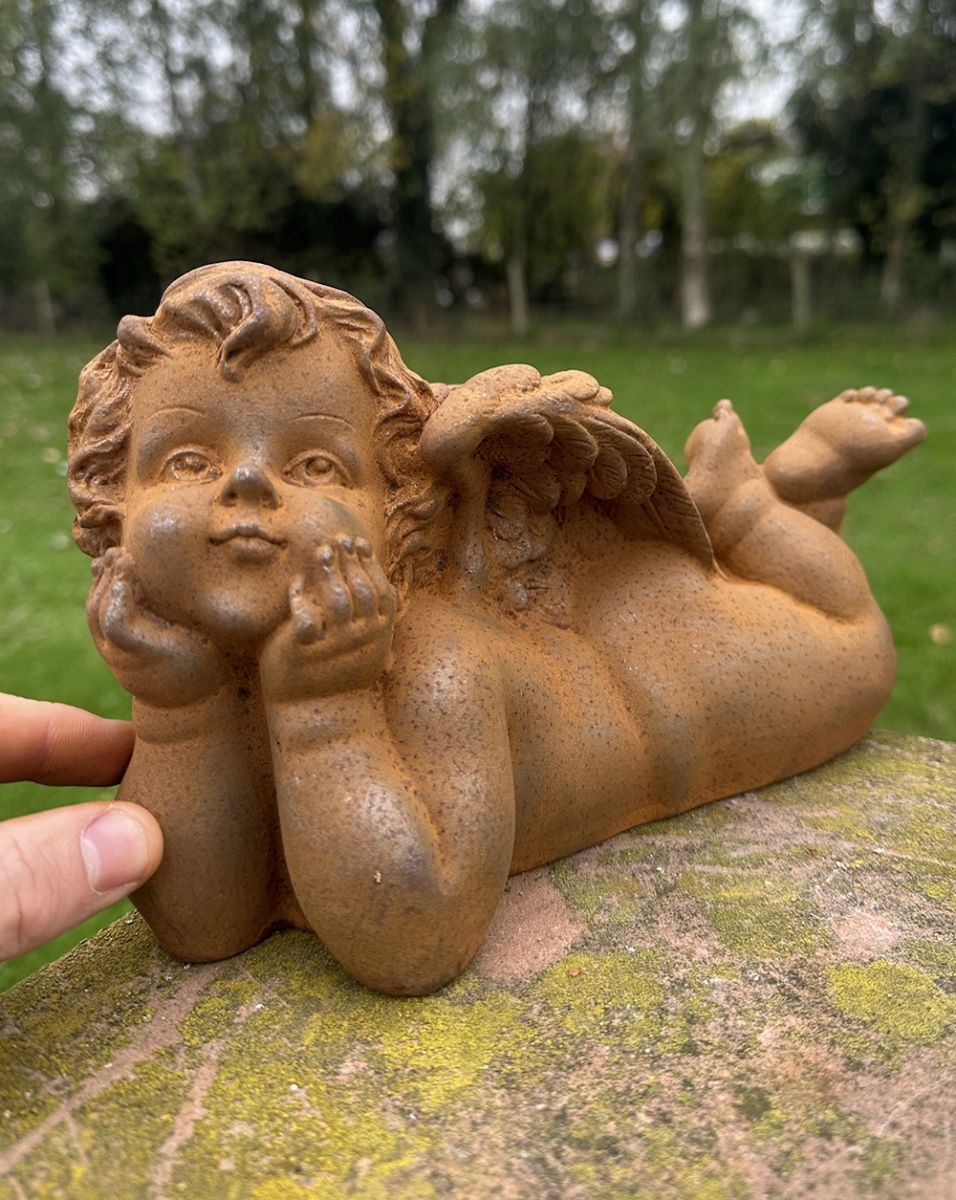 Scale image of Rustic Cast Iron Cherub Garden Sculpture