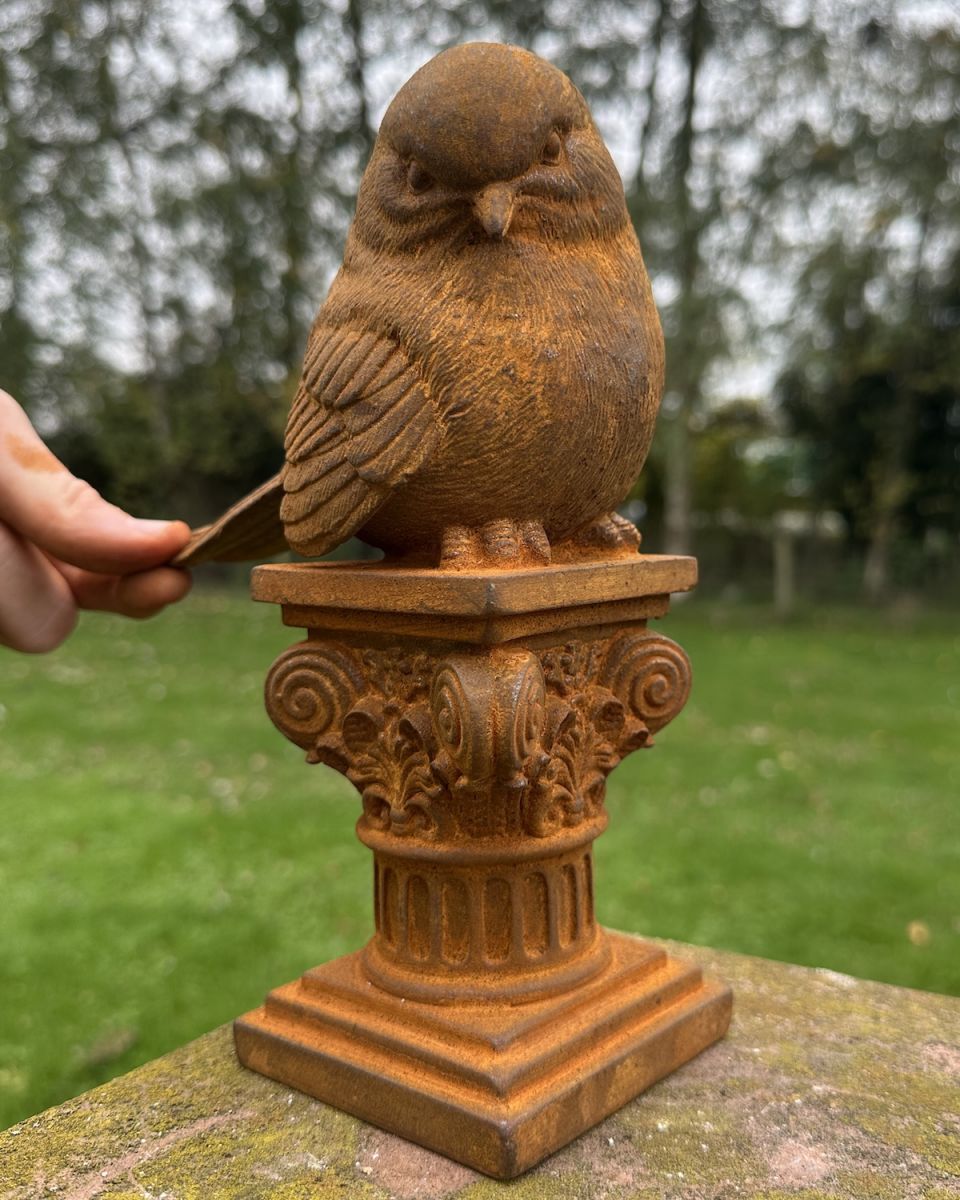 Scale image of rustic cast iron robin garden sculpture