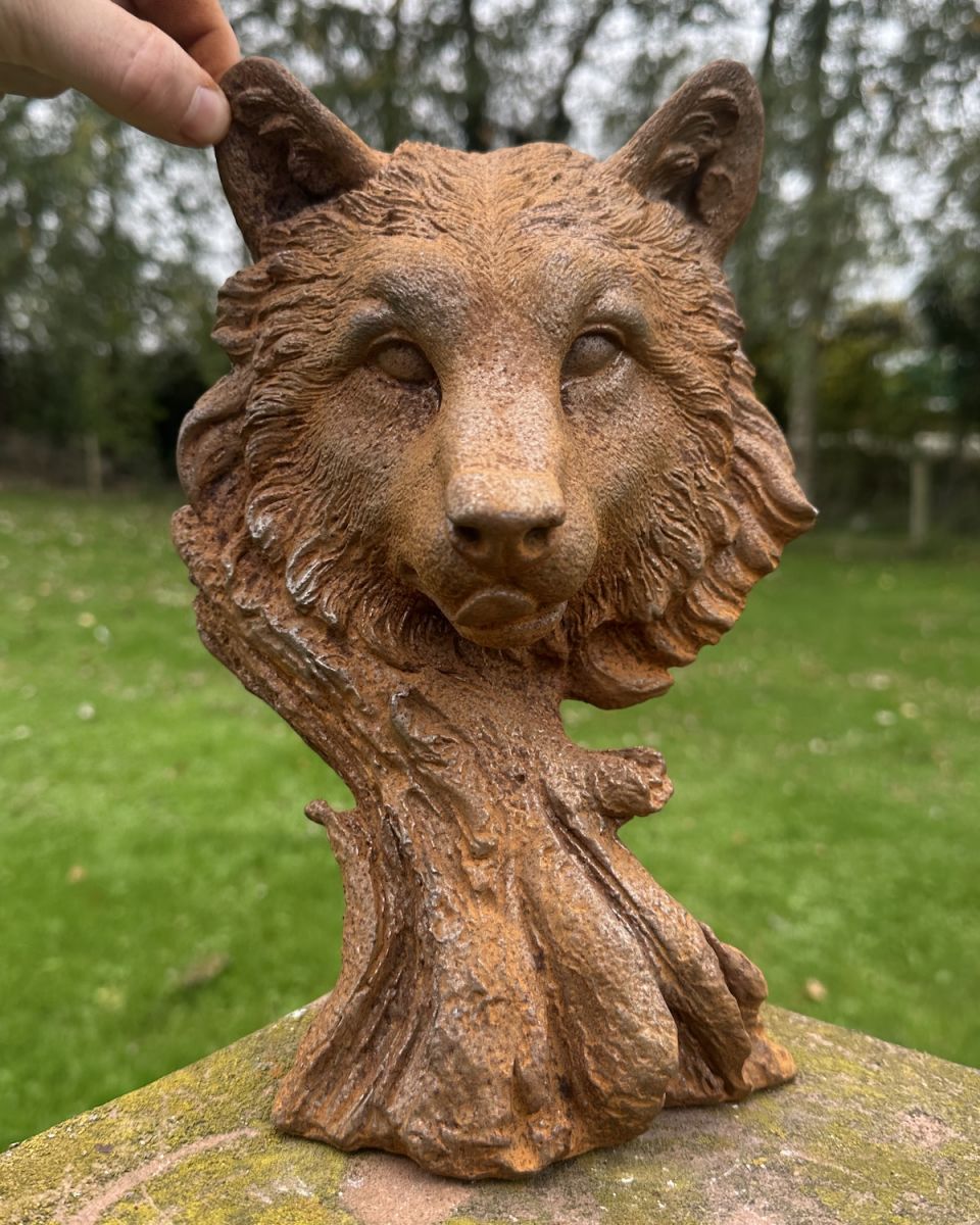 Scale image of rustic cast iron wolf face sculpture