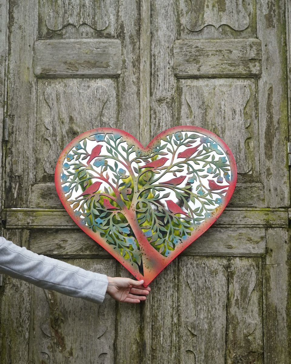 Scale image of colourful steel garden mirror wall art