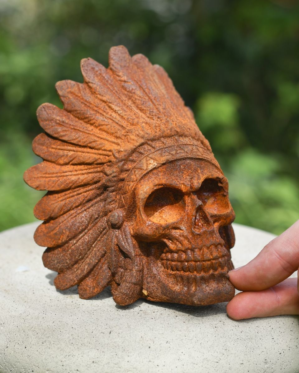 scale picture of cast iron skull in headdress garden ornament 