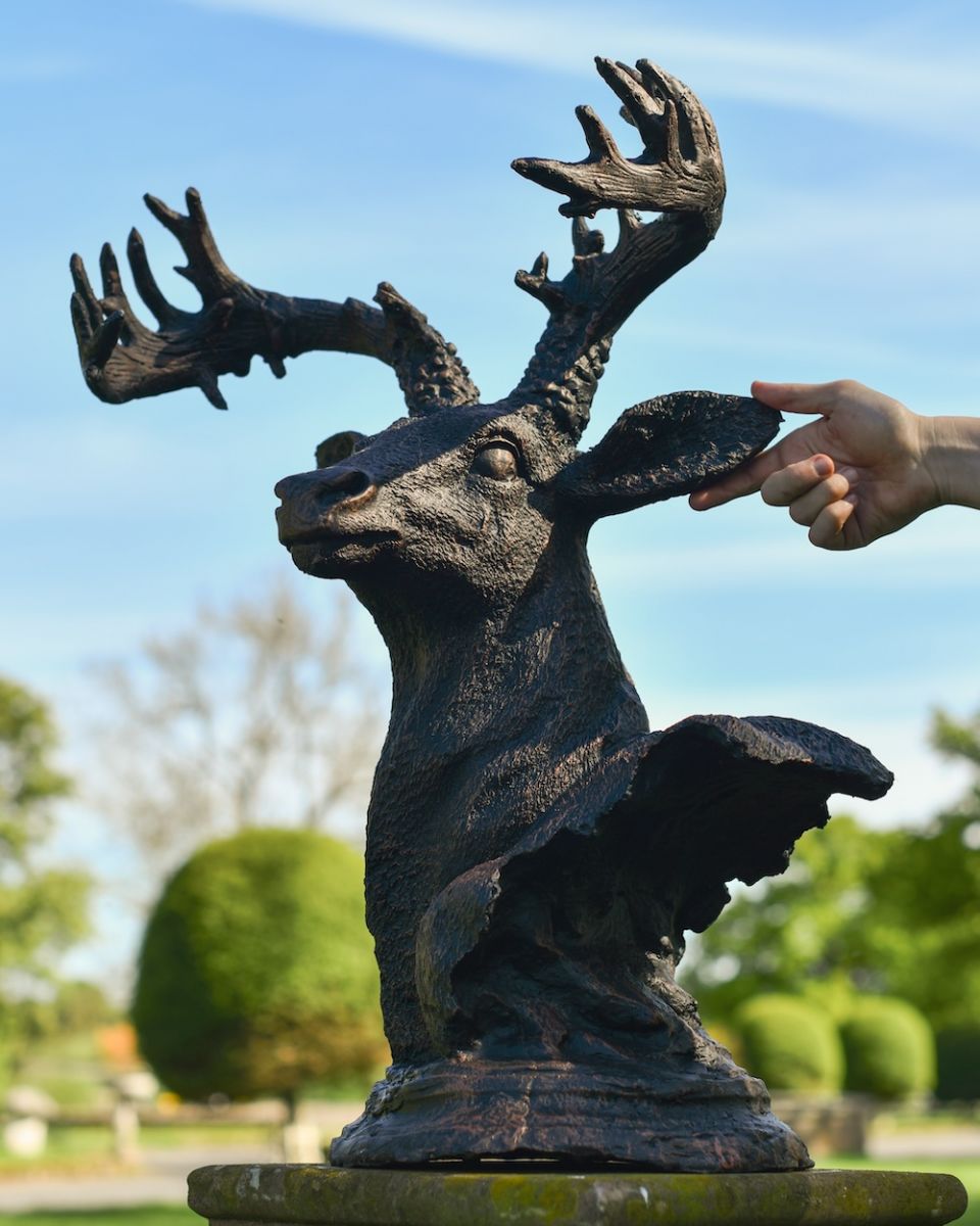 scale view of antique bronze stag bust 