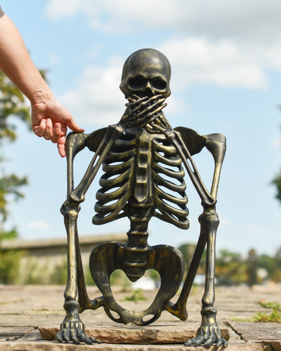 Scale image of brushed gold skeleton garden statue