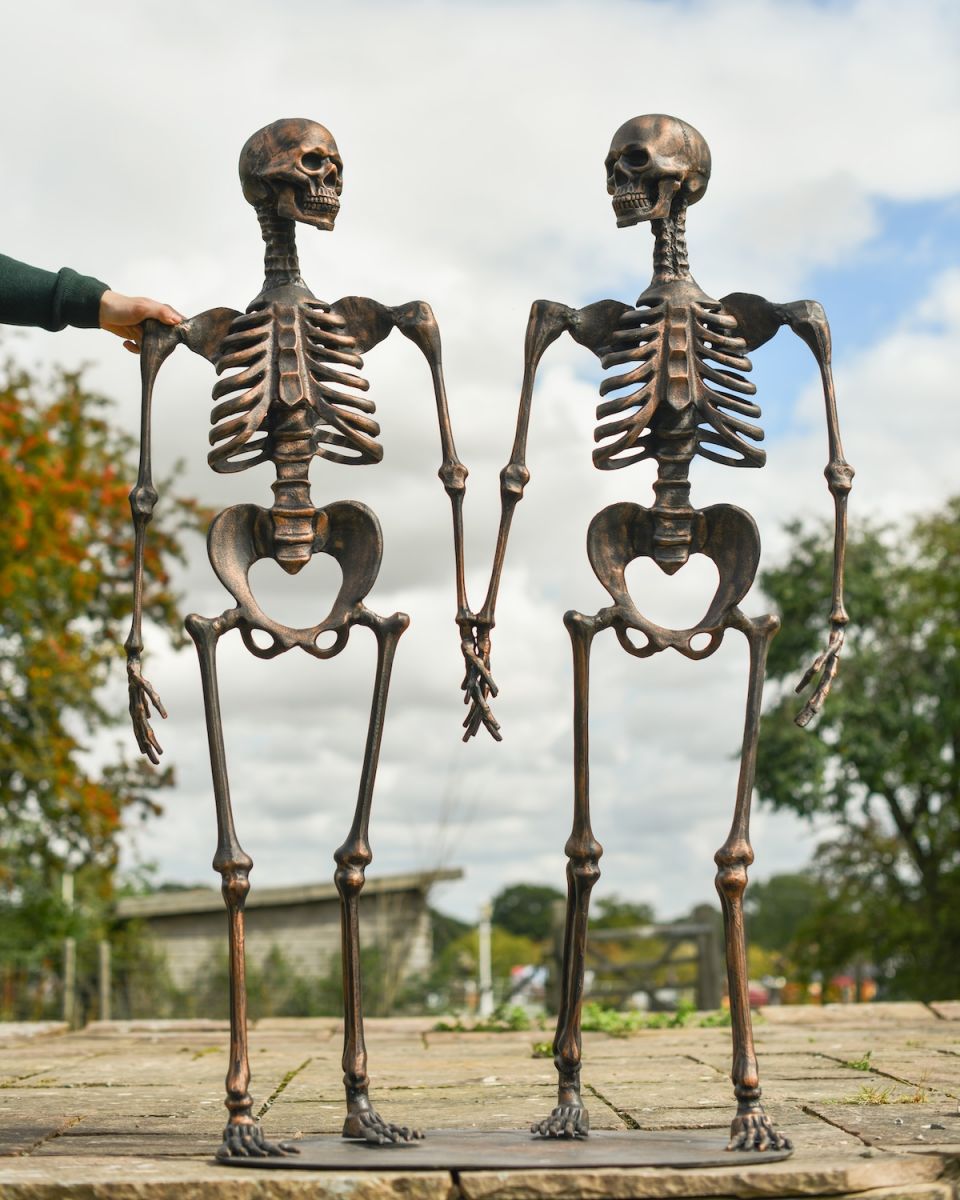 Scale image of skeletons art sculptures with freestanding base
