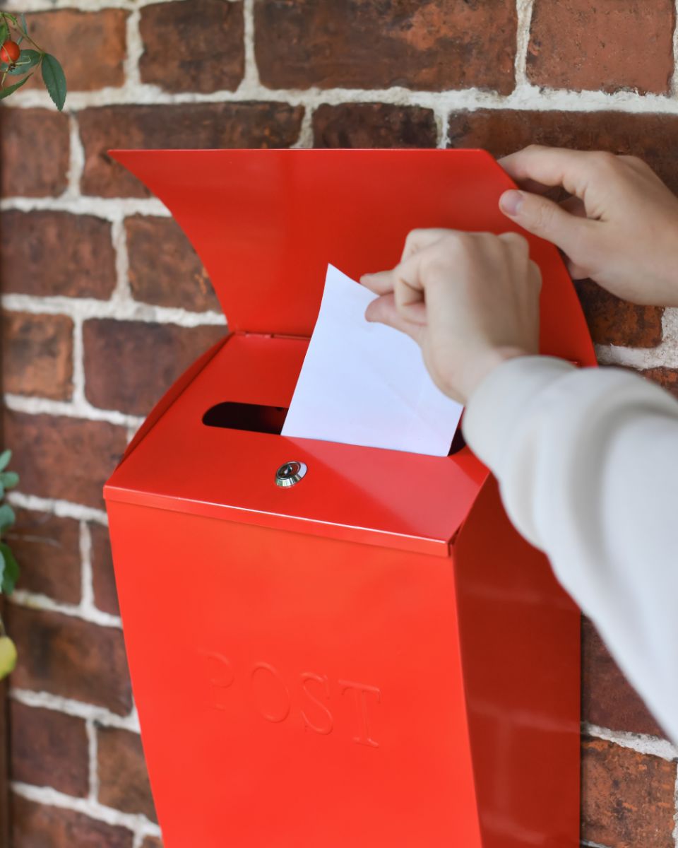 Scale Of The Letter flapp On The Red Wall Mounted Post box