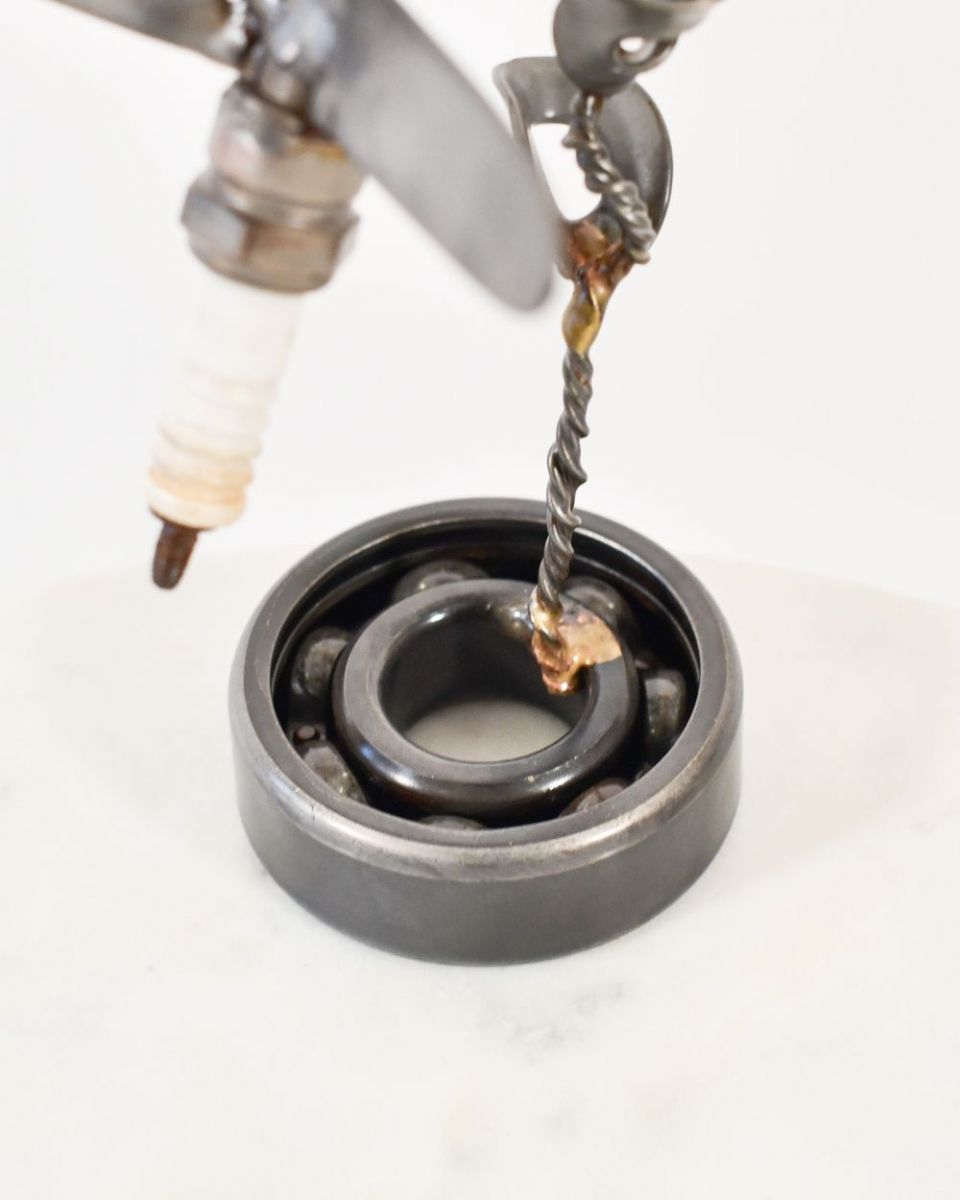 Close up of Spark Plug Hummingbird Recycled Metal Ornament base Close up of Spark Plug Hummingbird Recycled Metal Ornament base