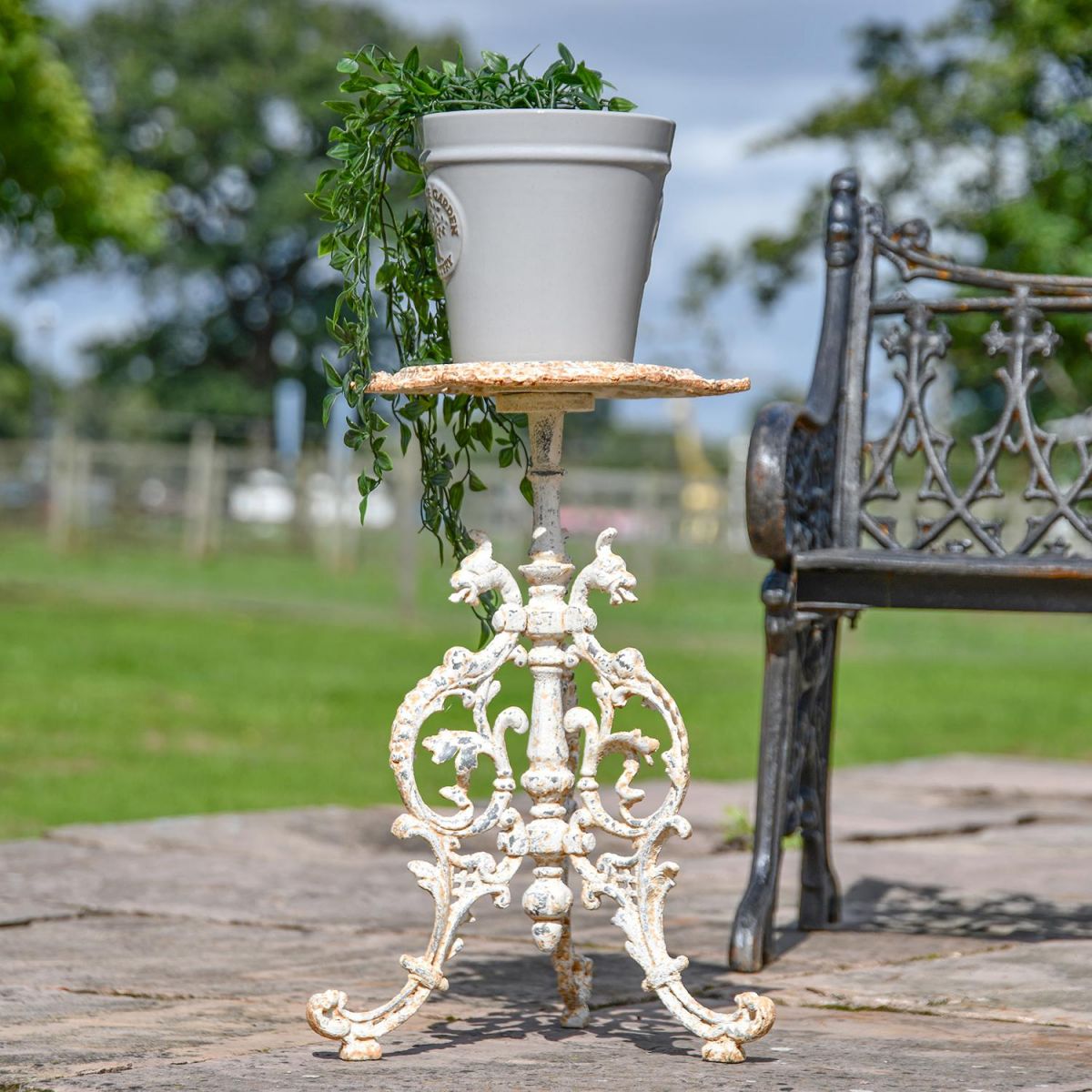 Serpent Gothic Rustic Cream Cast Iron Side Table Holding a Plant Pot Serpent Gothic Rustic Cream Cast Iron Side Table Holding a Plant Pot