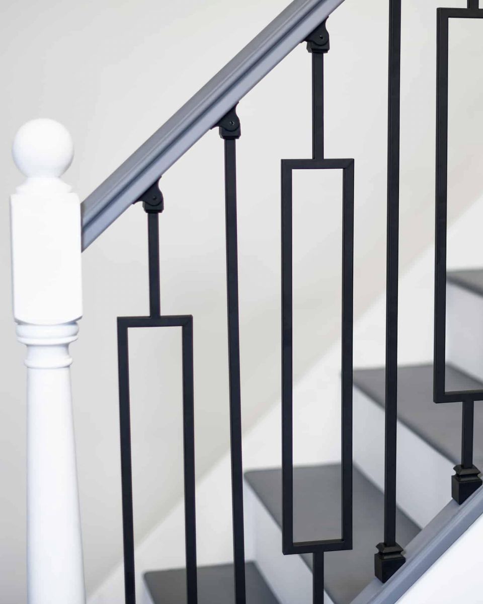 Close-Up of Set of 2 Matte Black "Enfield" Steel Stair Spindles - Pattern 10 in Situ