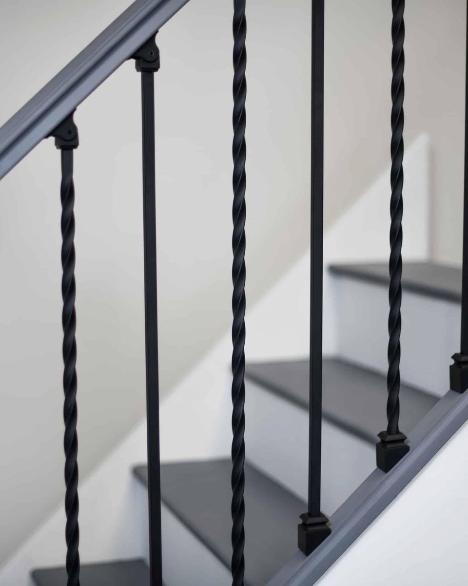Close- Up of Set of 2 Matte Black "Enfield" Steel Stair Spindles - Pattern 11 Close- Up of Set of 2 Matte Black "Enfield" Steel Stair Spindles - Pattern 11