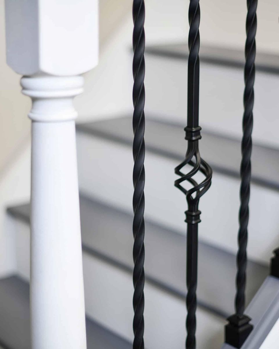 Close-Up of Set of 2 Matte Black "Enfield" Steel Stair Spindles - Pattern 13 in Situ