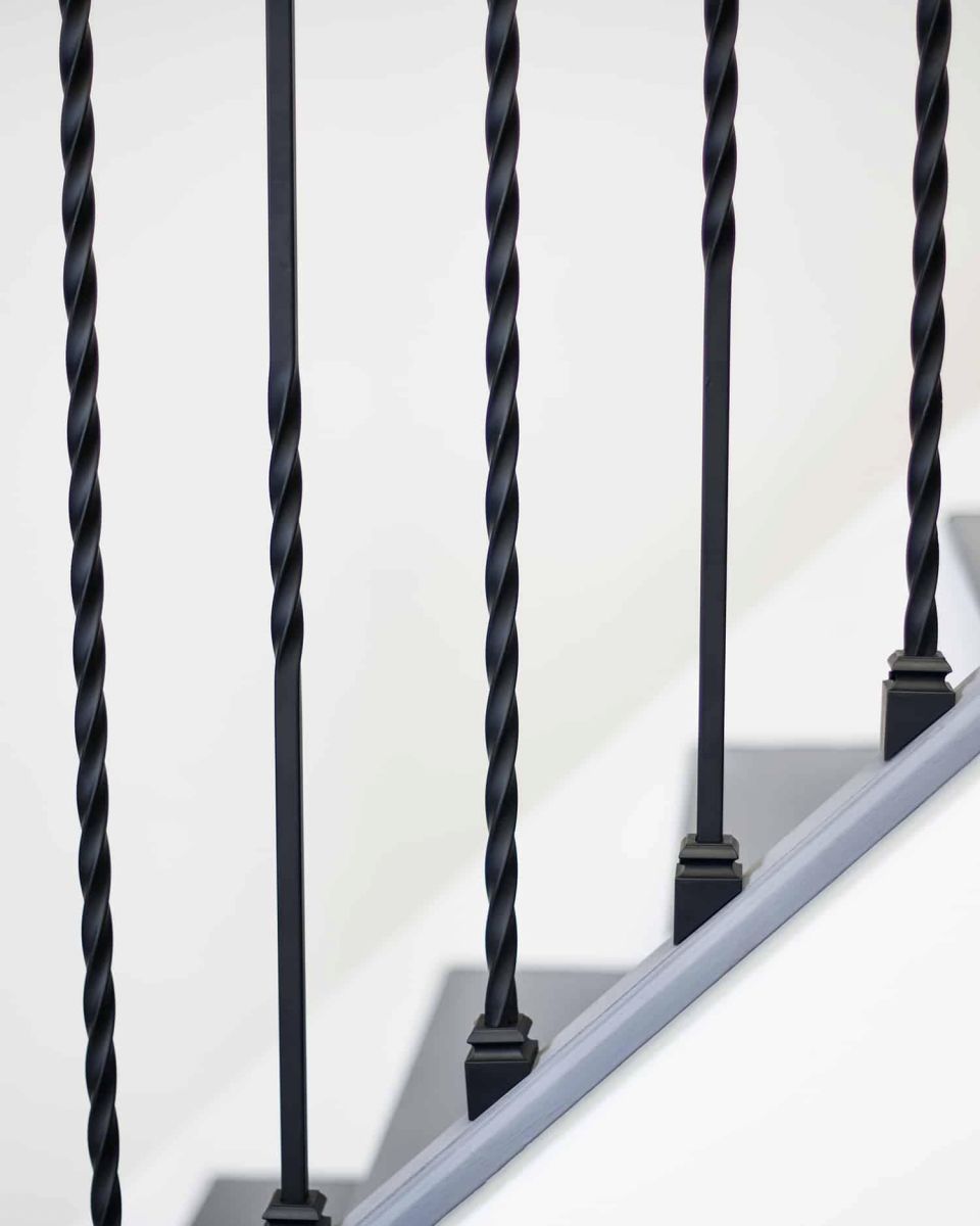 Close-Up of Set of 2 Matte Black "Enfield" Steel Stair Spindles - Pattern 15 in Situ
