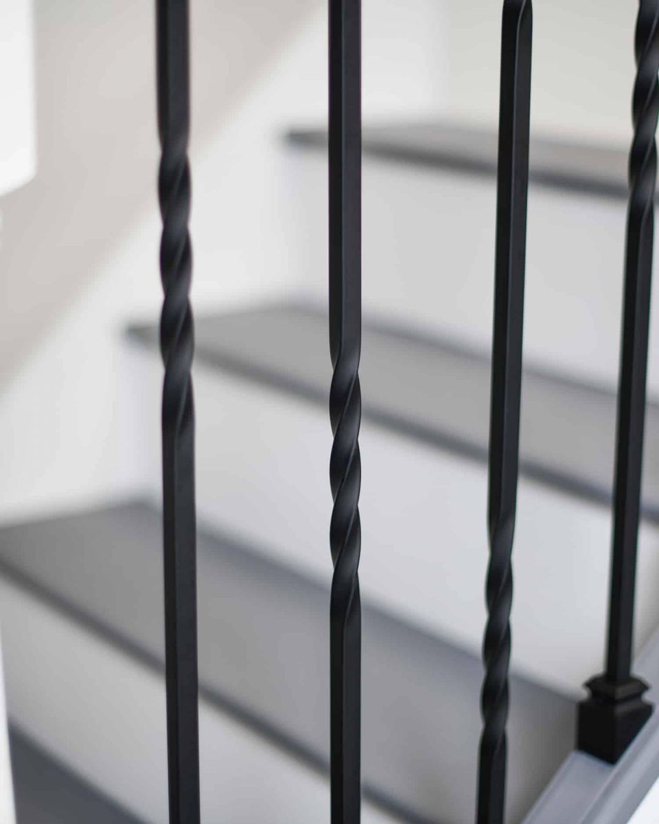 Close-Up of Set of 2 Matte Black "Enfield" Steel Stair Spindles - Pattern 4 in Situ