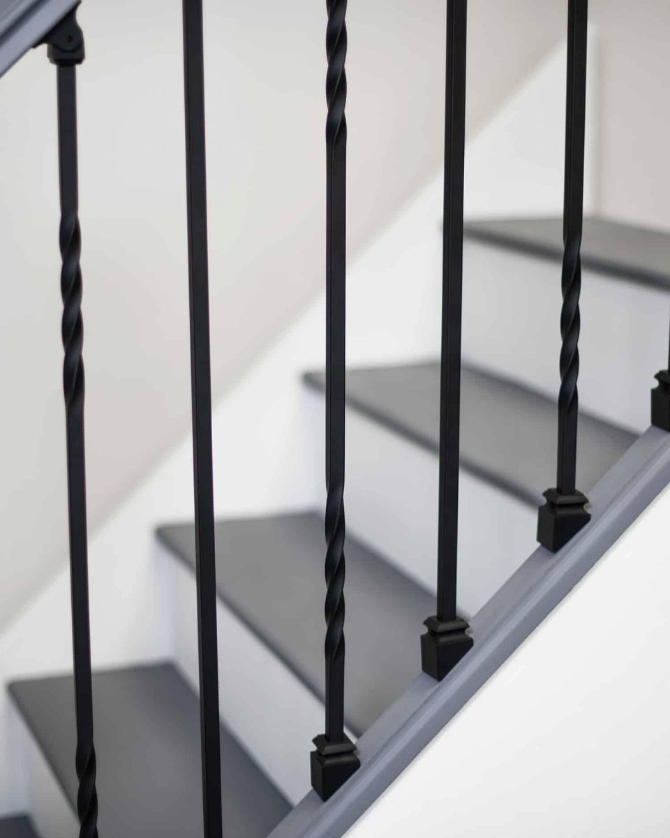 Close-Up of Set of 2 Matte Black "Enfield" Straight & Double Twist Stair Spindles - Pattern 2 with Fixed Rake Brackets