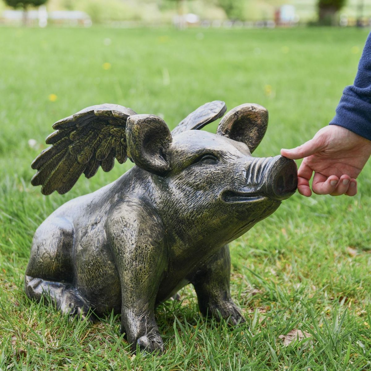 Brushed Gold Flying Pig with Hand for Scale  Brushed Gold Flying Pig with Hand for Scale
