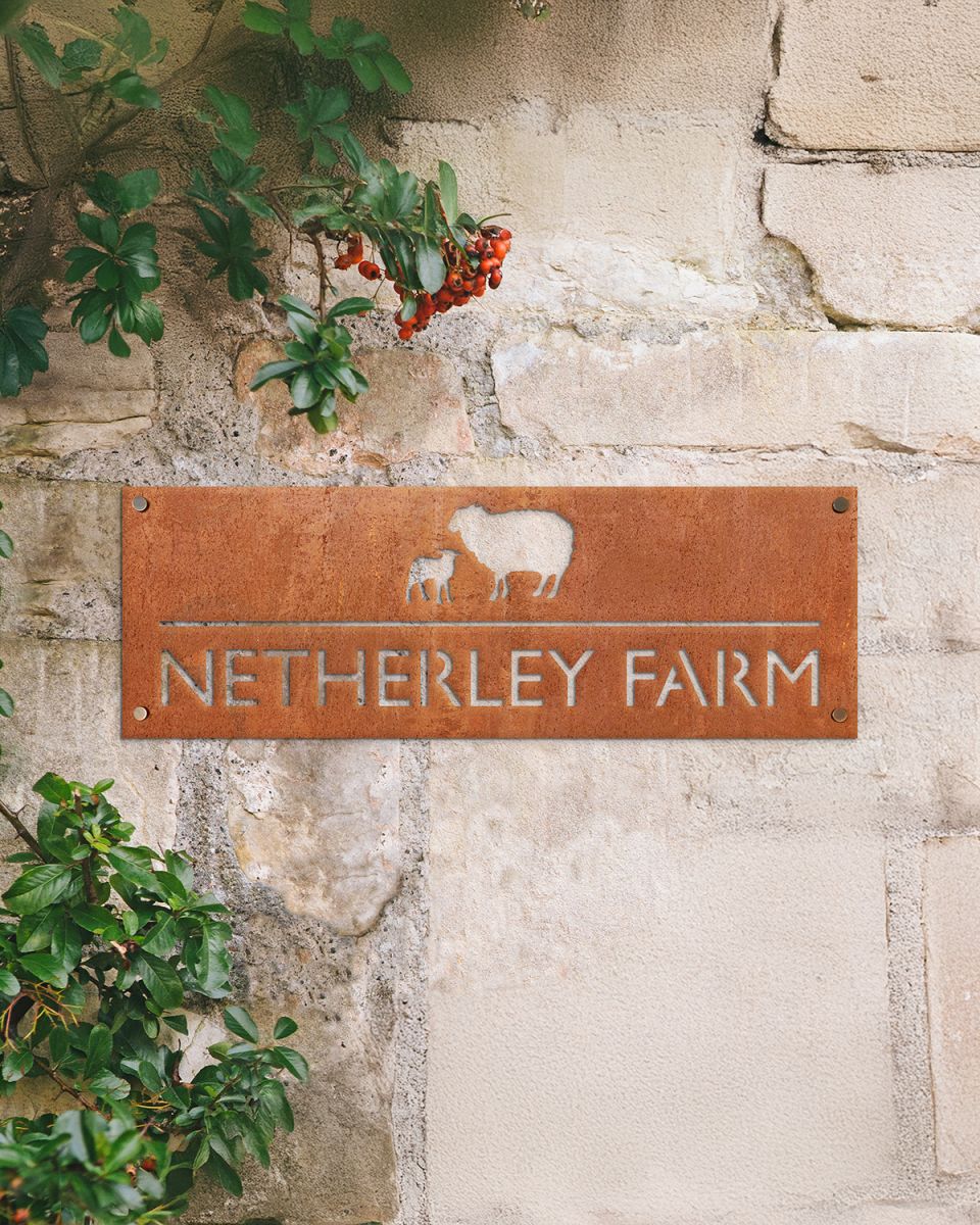 Sheep & Lamb Corten Steel House Name Sign in Situ on a Rustic Wall